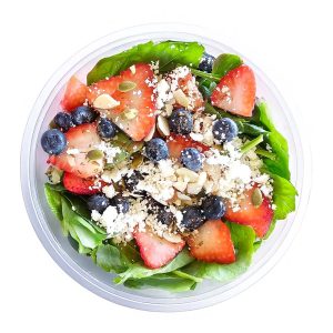 A vibrant Berry Salad with fresh greens, mixed berries, nuts, and a light dressing, served in a bowl.